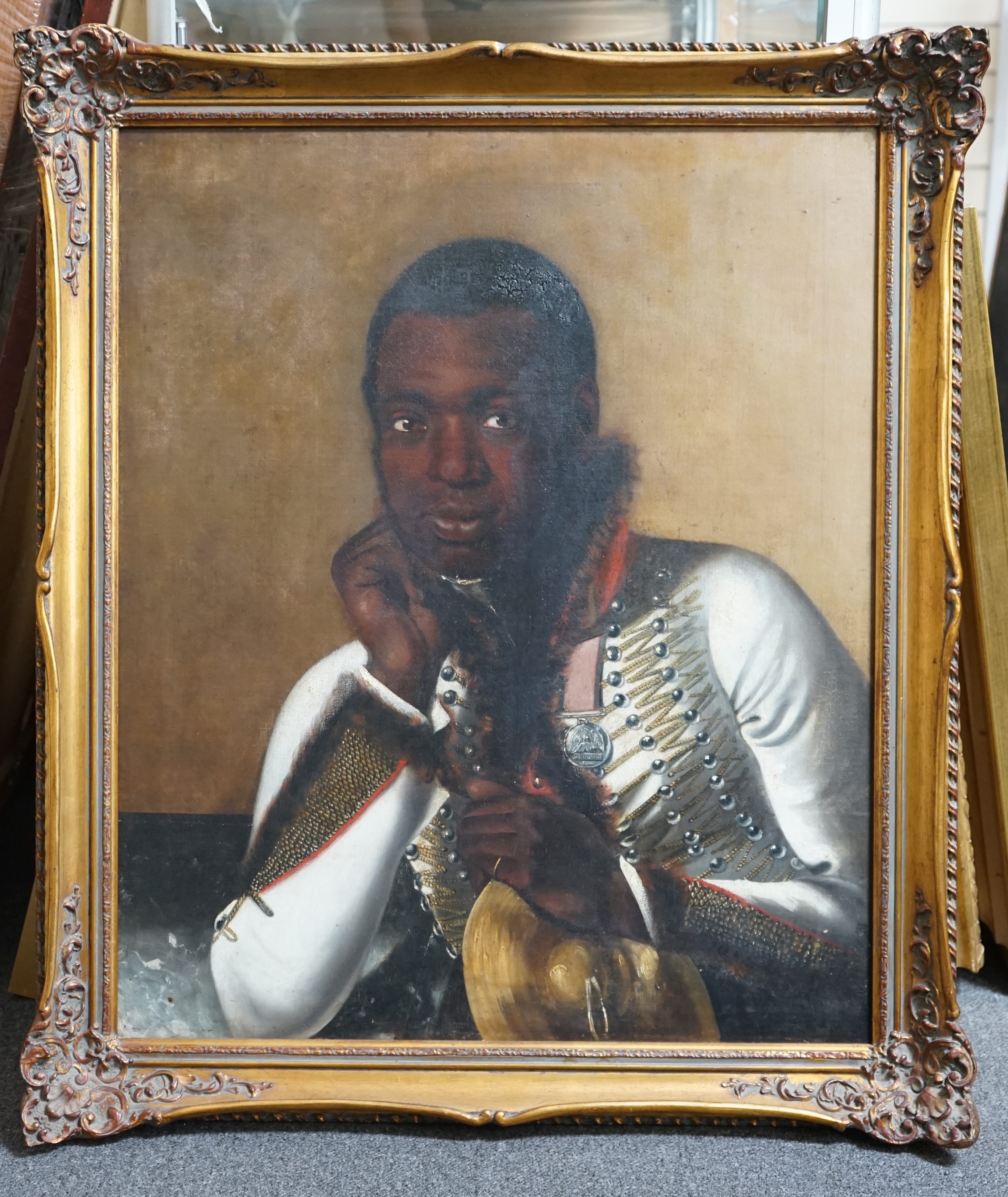 Early 19th century English School , Portrait of a black bandsman in uniform wearing the Waterloo medal and holding a cymbal, oil on canvas, 74 x 62cm